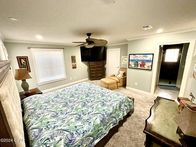 bedroom featuring ceiling fan, light tile patterned floors, crown molding, and a textured ceiling