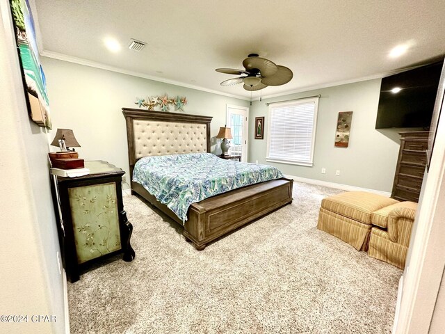 bedroom featuring carpet flooring, ornamental molding, and ceiling fan