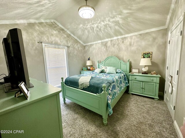 bedroom featuring ornamental molding, vaulted ceiling, a textured ceiling, and carpet