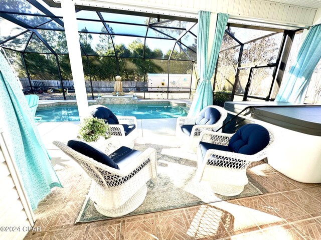 view of swimming pool featuring a lanai and a patio area