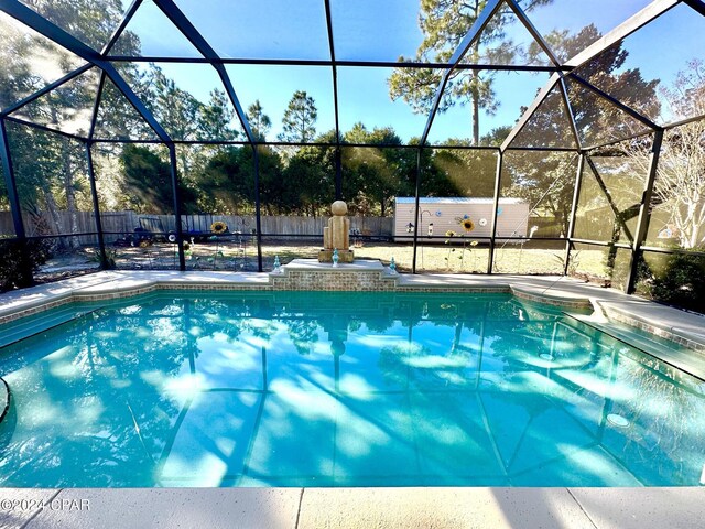 view of pool featuring glass enclosure