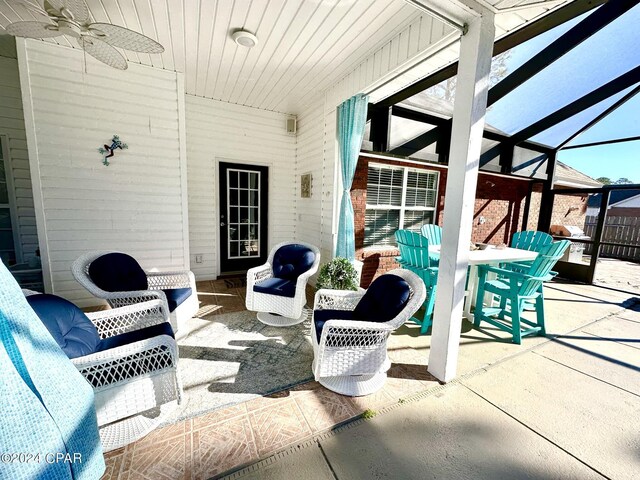 view of patio featuring a lanai and ceiling fan