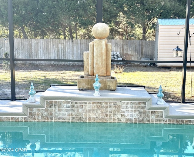 view of pool with a shed