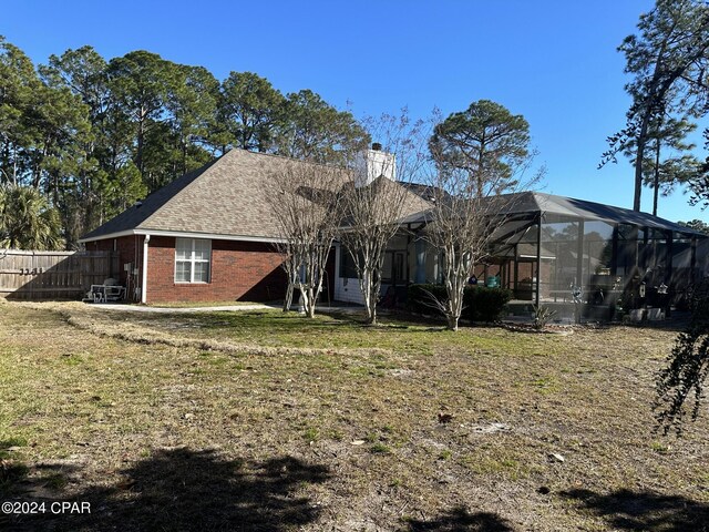 rear view of property featuring a yard