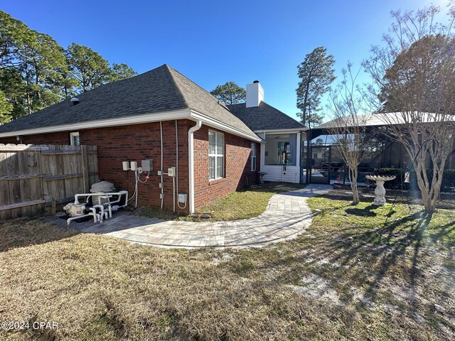 rear view of house with a yard and a patio