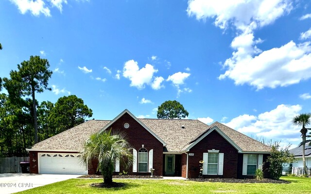 single story home with a front yard and a garage