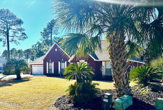 view of front of property featuring a garage and a front lawn