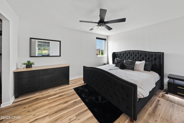 bedroom with ceiling fan and light hardwood / wood-style floors