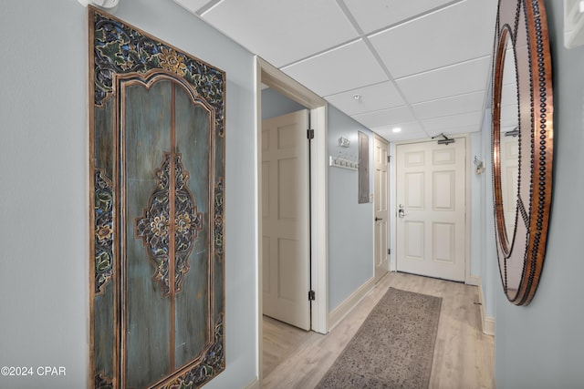 hallway featuring light hardwood / wood-style floors and a drop ceiling