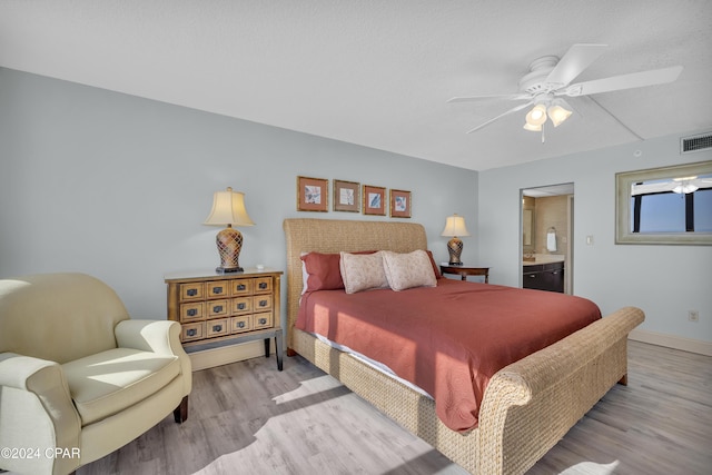 bedroom featuring a textured ceiling, ceiling fan, light wood-type flooring, and ensuite bathroom