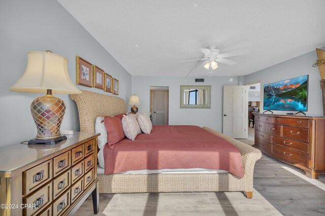 bedroom with ceiling fan and light wood-type flooring