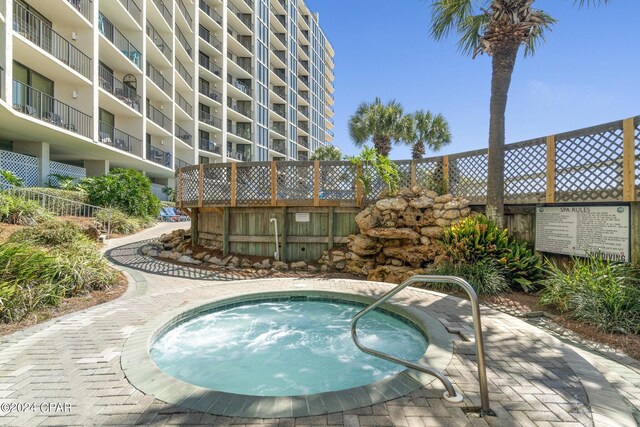 view of swimming pool with a community hot tub