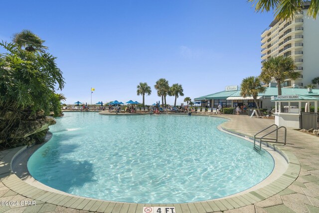 view of swimming pool featuring a patio area and a water view