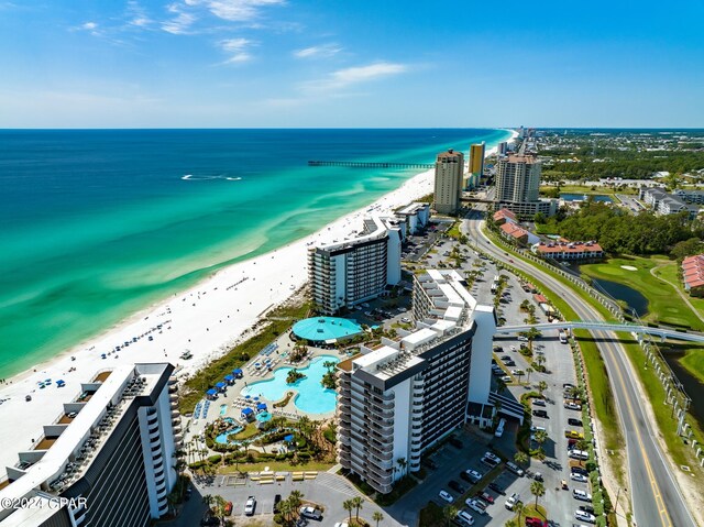 bird's eye view featuring a water view and a beach view