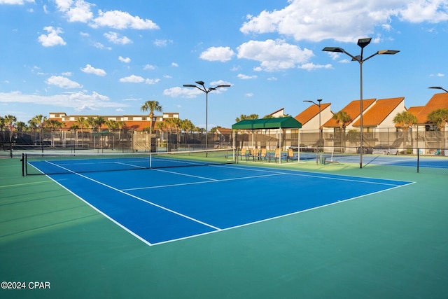 view of tennis court featuring basketball court