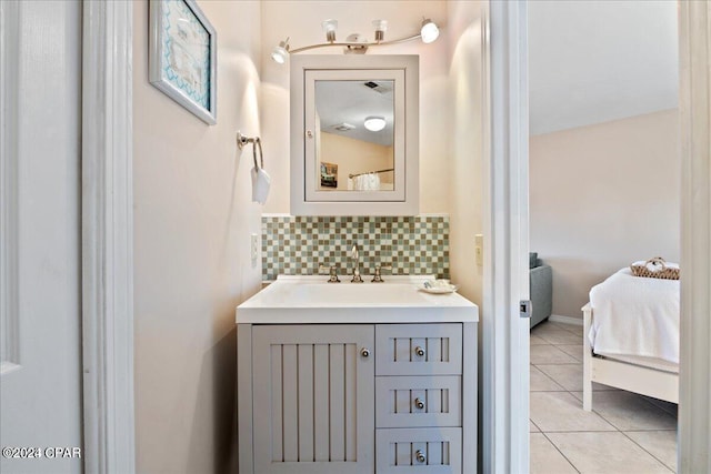 bathroom featuring tile patterned floors, vanity, and tasteful backsplash