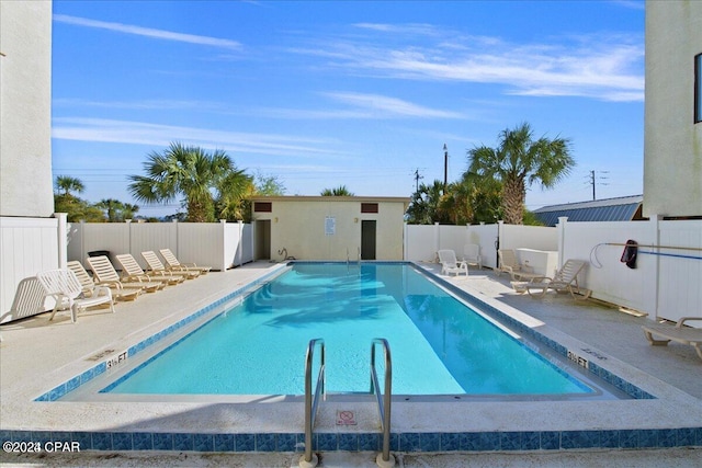 view of swimming pool with a patio area