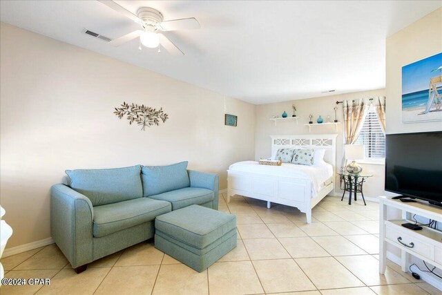 tiled bedroom featuring ceiling fan