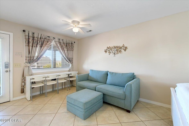 sitting room with ceiling fan and light tile patterned floors