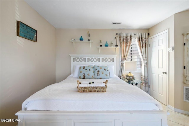 bedroom featuring light tile patterned flooring