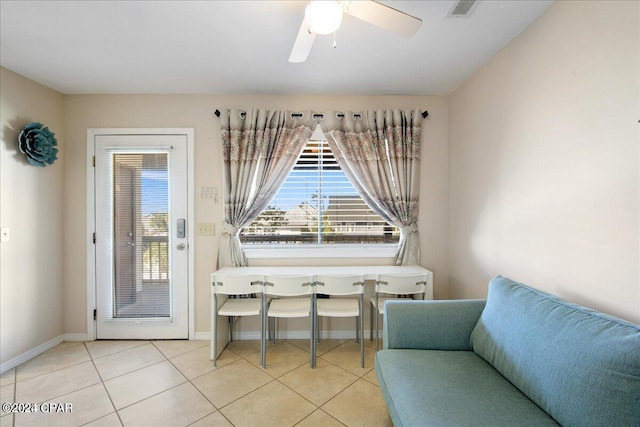 sitting room featuring light tile patterned flooring and ceiling fan