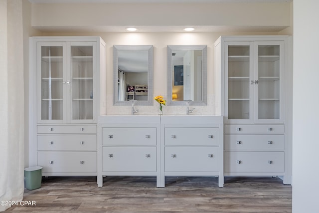 interior space with vanity and hardwood / wood-style floors