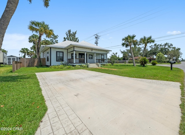 view of front of property with a front yard and covered porch