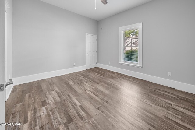 spare room with ceiling fan and wood-type flooring