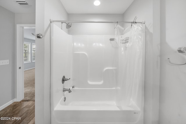 bathroom with shower / tub combo and hardwood / wood-style flooring