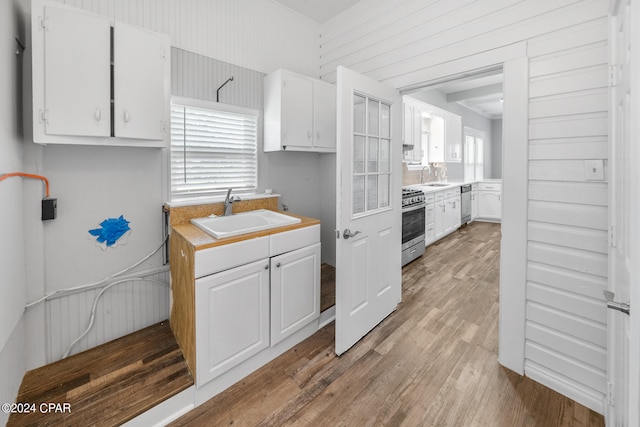 kitchen featuring white cabinets and light hardwood / wood-style flooring