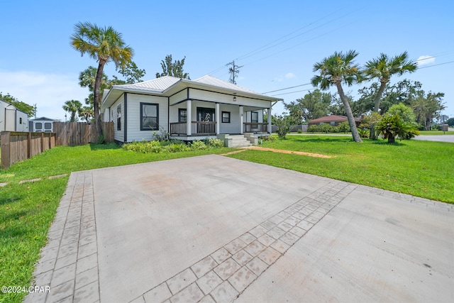 view of front of property with covered porch and a front lawn