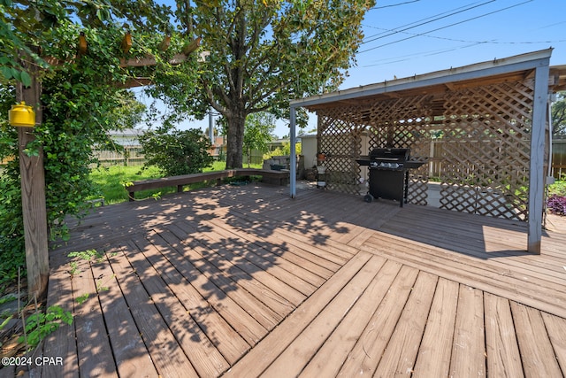 wooden terrace featuring grilling area