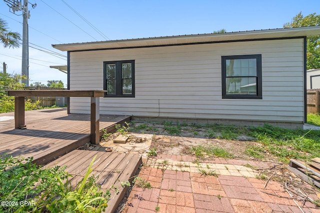 view of home's exterior featuring a wooden deck