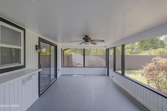 unfurnished sunroom featuring ceiling fan