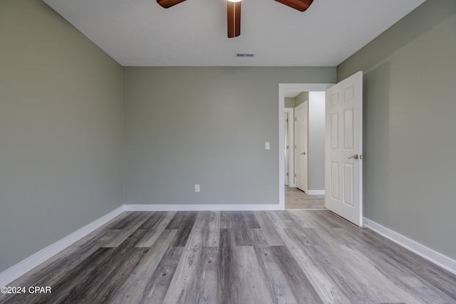 spare room with light hardwood / wood-style floors and ceiling fan