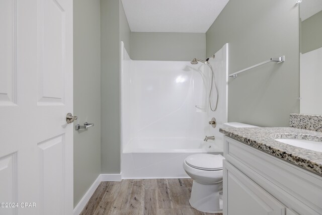 full bathroom with vanity, toilet, shower / washtub combination, and hardwood / wood-style floors