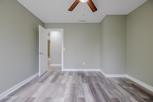 unfurnished room featuring light wood-type flooring and ceiling fan