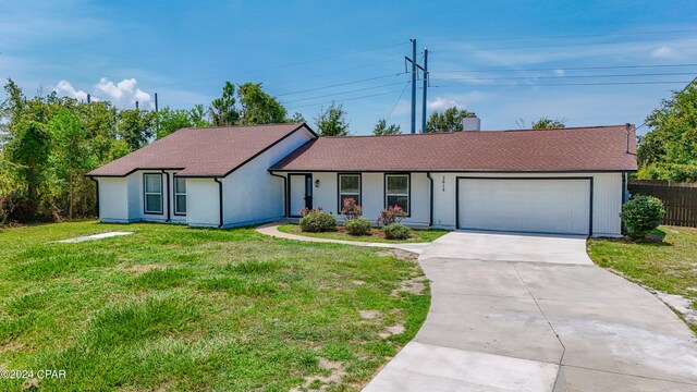 ranch-style house with a front yard and a garage