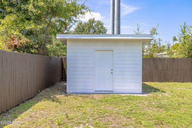 view of outdoor structure featuring a lawn