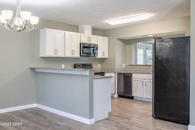 kitchen featuring kitchen peninsula, white cabinets, stainless steel appliances, and light wood-type flooring