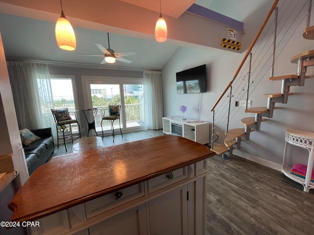 kitchen featuring ceiling fan, dark hardwood / wood-style flooring, vaulted ceiling, and hanging light fixtures