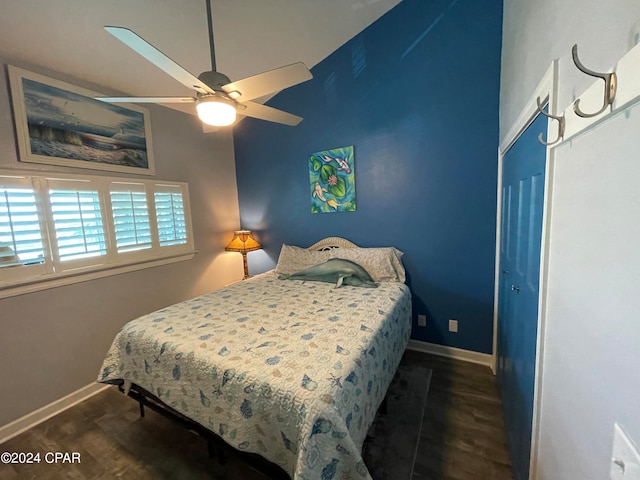 bedroom with ceiling fan, a closet, and dark wood-type flooring