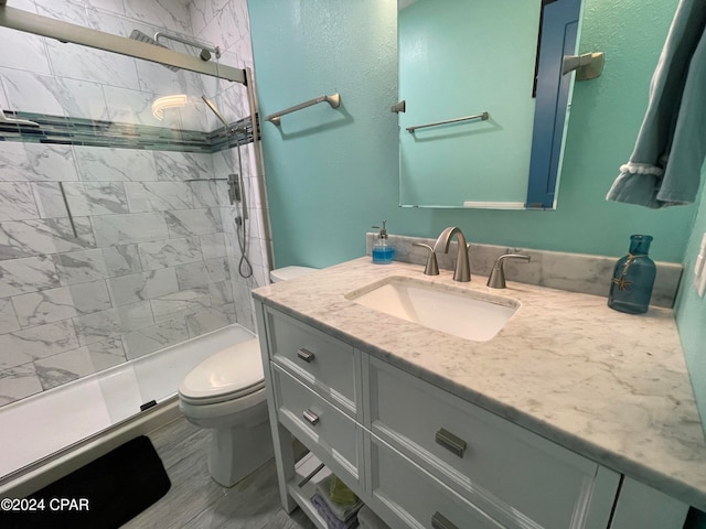 bathroom featuring a shower with door, toilet, vanity, and hardwood / wood-style flooring