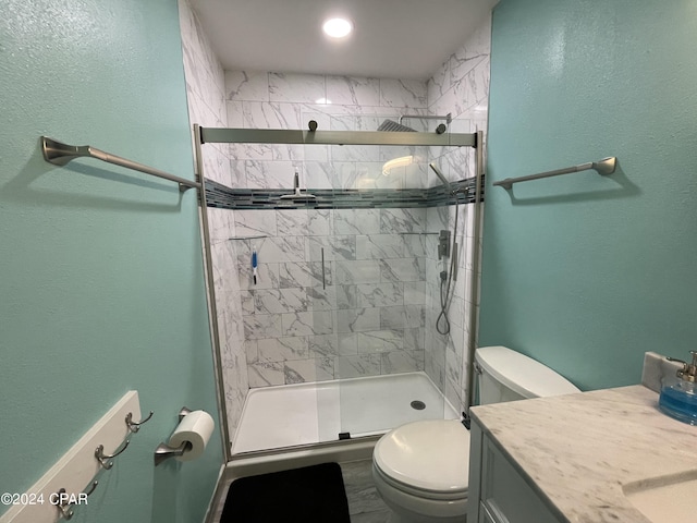 full bath with toilet, a stall shower, and vanity