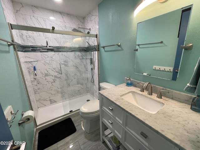 bathroom with toilet, a stall shower, and vanity