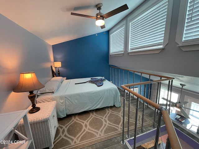 bedroom featuring ceiling fan, lofted ceiling, and hardwood / wood-style floors