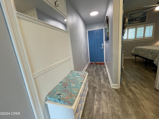 interior space featuring baseboards and wood finished floors