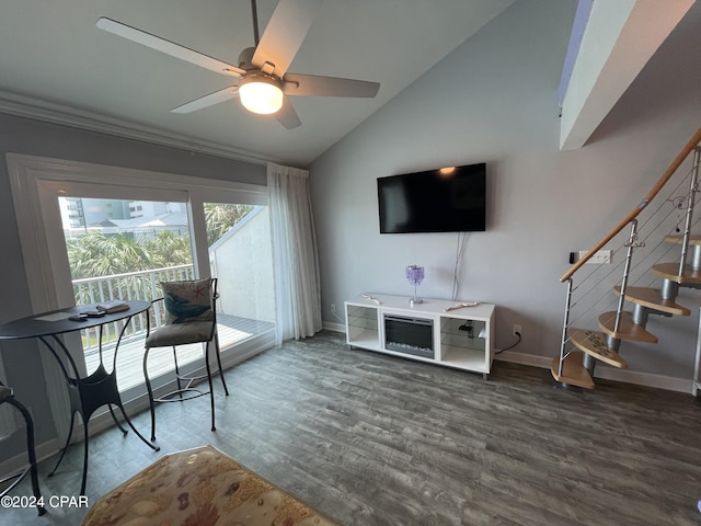 living area featuring lofted ceiling, dark wood finished floors, baseboards, ceiling fan, and stairs