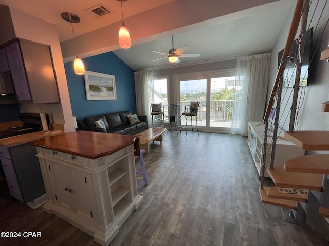 kitchen with decorative light fixtures, lofted ceiling, dark wood-type flooring, white cabinets, and ceiling fan