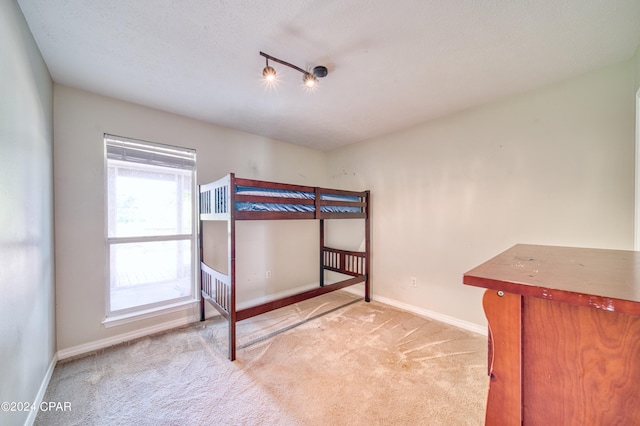 unfurnished bedroom with light carpet and baseboards